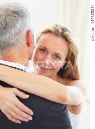 Portrait, love and a woman hugging her husband on their wedding day for romance or commitment. Face, smile and a bride embracing her groom for trust, safety or security during a marriage ceremony Portrait, love and a woman hugging her husband on their wedding day for romance or commitment. Face, smile and a bride embracing her groom for trust, safety or security during a marriage ceremony 139305284