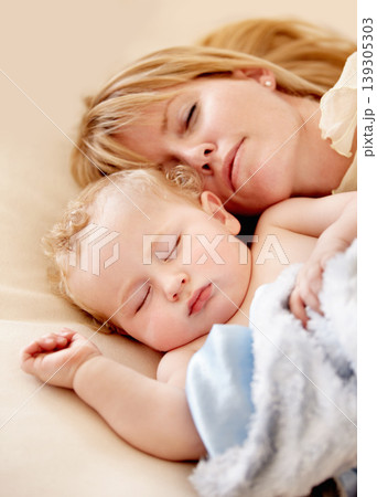 Sleeping, mom and baby with peace in bed together with calm moment with love for infant and kid in morning nap. Mother, cuddle and sleep with child in closeup and rest in bedroom or family home 139305303