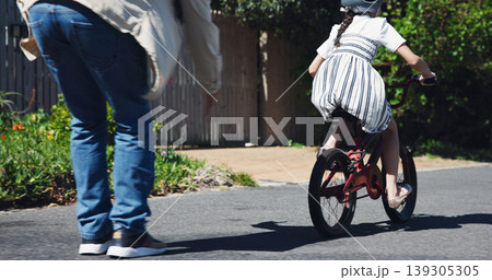Dad, child and teaching bicycle ride for safety, outdoor street and having fun learning to cycle. Cycling, childhood memory and riding in summer with helmet, bonding together and recreation activity Dad, child and teaching bicycle ride for safety, outdoor street and having fun learning to cycle. Cycling, childhood memory and riding in summer with helmet, bonding together and recreation activity 139305305