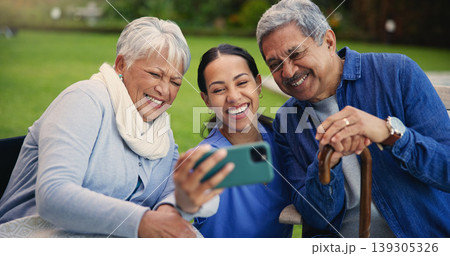 Happy woman, doctor and senior people in selfie for photography, elderly care or retirement in nature. Medical nurse or caregiver smile with mature couple for picture, photograph or memory at park Happy woman, doctor and senior people in selfie for photography, elderly care or retirement in nature. Medical nurse or caregiver smile with mature couple for picture, photograph or memory at park 139305326