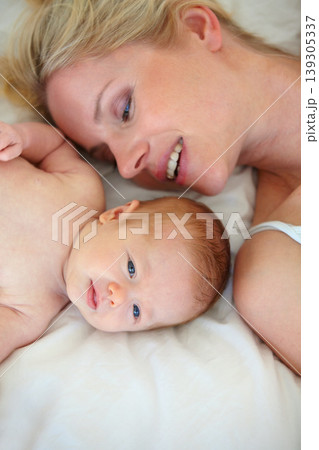 Relax, smile and bed, mother and baby bonding, woman and kid lying in home together. Calm morning, mom and newborn in bedroom for rest, love and happy family growth, comfort and child care from above Relax, smile and bed, mother and baby bonding, woman and kid lying in home together. Calm morning, mom and newborn in bedroom for rest, love and happy family growth, comfort and child care from above 139305337