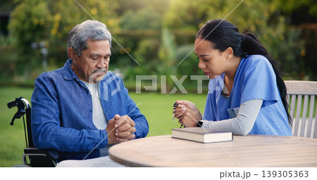 Wheelchair, praying or nurse with senior man for care, support or trust in retirement or nature. Caregiver, help and person or elderly patient with a disability or medical professional for worship Wheelchair, praying or nurse with senior man for care, support or trust in retirement or nature. Caregiver, help and person or elderly patient with a disability or medical professional for worship 139305363
