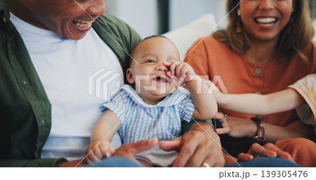 Family, smile and play on couch, baby and bonding or love, relax and support or laughing at home. Happy parents and children, connect and humor or funny, joy and relaxed or silly, goofy and closeup Family, smile and play on couch, baby and bonding or love, relax and support or laughing at home. Happy parents and children, connect and humor or funny, joy and relaxed or silly, goofy and closeup 139305476