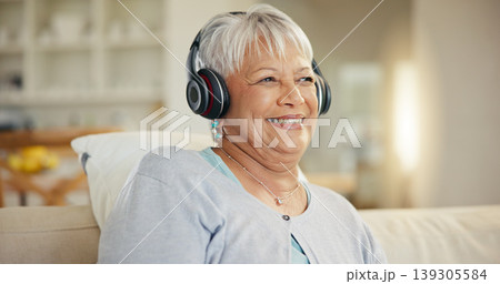 Senior woman, home and headphones for music, listening to audio and radio podcast on sofa. Happy elderly lady, relax and thinking of peace, streaming sound and multimedia subscription in living room Senior woman, home and headphones for music, listening to audio and radio podcast on sofa. Happy elderly lady, relax and thinking of peace, streaming sound and multimedia subscription in living room 139305584