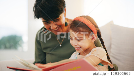 Grandparent, kid and reading book with smile, home and child development, grandchild and couch. Woman, lounge or bonding together for relationship, family and retired with girl, house and happy 139305663
