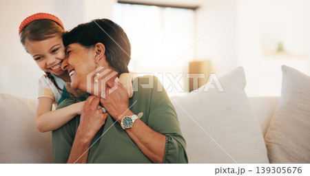 Child, grandmother and hug on sofa happy for laugh bonding, relax connection in retirement. Girl, old woman and embrace on couch for holiday rest or together in lounge for funny joke, love or care 139305676