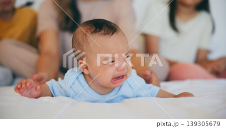Crying, sad or baby with mother in bed for comfort, safety and attention while hungry, sick or tired. Noise, angry infant or young child upset with woman babysitter, mommy or nanny in family home 139305679