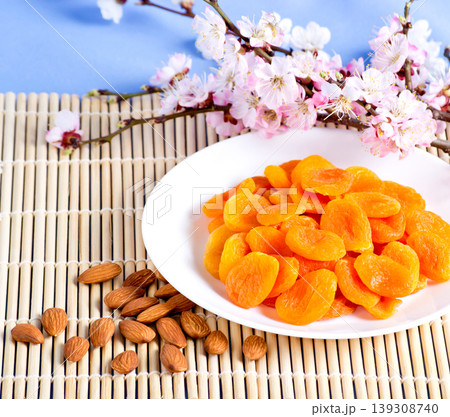 Dried apricots with almonds and blossoming branch Dried apricots with almonds and blossoming branch 139308740
