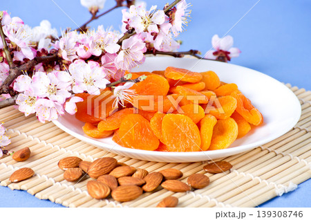 Dried apricots with almonds and blossoming branch Dried apricots with almonds and blossoming branch 139308746