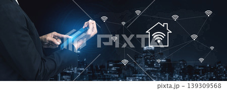 Modern Businessman Using Tablet Device to Control Smart Home Technology with Wireless Connectivity in Urban Cityscape at Night Gantry Modern Businessman Using Tablet Device to Control Smart Home Technology with Wireless Connectivity in Urban Cityscape at Night Gantry 139309568