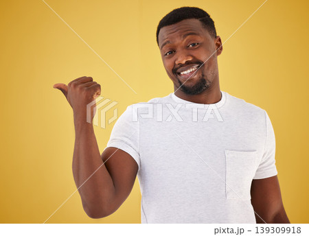 Man, portrait and smile or pointing in studio on yellow background, mockup space for choice information. Black person, face with hand gesture for decision show launch, promo deal or offer opinion 139309918