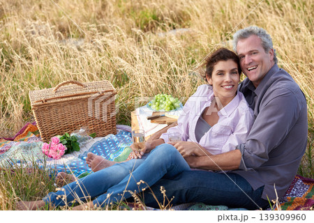 Old couple, relax and portrait of picnic in park for a date with love, care or support in marriage. Happy, man and woman on grass with food, flowers and celebration in retirement, holiday or vacation 139309960