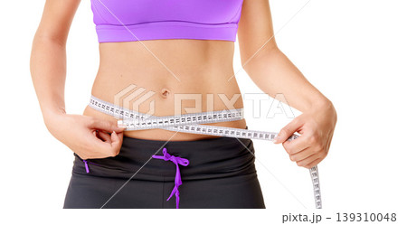 Weight loss, woman or measuring tape with stomach in studio for fitness, wellness or body progress or diet. Person, belly or waist with target for exercise, training or workout on white background 139310048