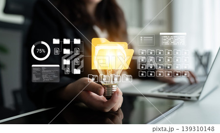 Business professional holding light bulb with data visualization icons representing innovation, technology, and modern workspace productivity Ledger Business professional holding light bulb with data visualization icons representing innovation, technology, and modern workspace productivity Ledger 139310148