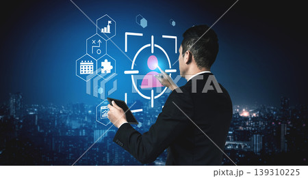 Businessman Using Tablet for Data Analysis with User Interface Graphics and Background Cityscape at Night for Technology Concept Gantry 139310225