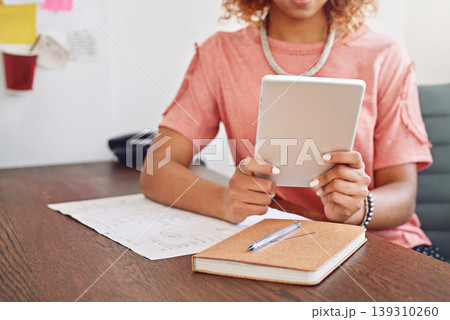 Hands, notebook or designer with tablet for research, technology or analysis online on website. News, email or closeup of woman working on iot or digital update on internet or app in startup office Hands, notebook or designer with tablet for research, technology or analysis online on website. News, email or closeup of woman working on iot or digital update on internet or app in startup office 139310260