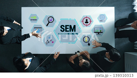 Professional Team Collaborating on Search Engine Marketing Strategy with Visual Data Presentation and Modern Digital Tools Fluxor Professional Team Collaborating on Search Engine Marketing Strategy with Visual Data Presentation and Modern Digital Tools Fluxor 139310313