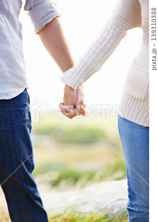 Holding hands, closeup and couple on holiday at beach with love, trust and support on journey together. Marriage, man and woman in nature, walking with care and respect for partnership or bonding Holding hands, closeup and couple on holiday at beach with love, trust and support on journey together. Marriage, man and woman in nature, walking with care and respect for partnership or bonding 139310388