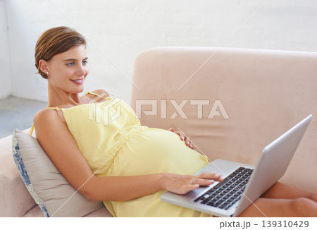Happy, pregnant or woman on laptop in house living room for childcare website, information or birth wellness learning. Smile, relax or person on home sofa with technology, research and pregnancy blog Happy, pregnant or woman on laptop in house living room for childcare website, information or birth wellness learning. Smile, relax or person on home sofa with technology, research and pregnancy blog 139310429