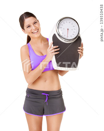 Scale, portrait and happy woman with exercise, weight loss and smile from health progress. Workout, fitness and sport training of a female person in studio with white background and wellness care 139310438