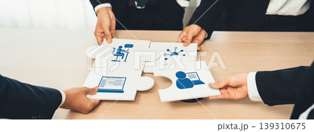 Diverse Business Professionals Collaborating on Puzzle Pieces, Symbolizing Teamwork and Strategy in Modern Office Environment. Amity Diverse Business Professionals Collaborating on Puzzle Pieces, Symbolizing Teamwork and Strategy in Modern Office Environment. Amity 139310675