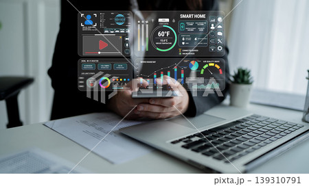 Business Professional Using Smartphone with Smart Home Dashboard and Data Visualization in Modern Office Environment Fluxor Business Professional Using Smartphone with Smart Home Dashboard and Data Visualization in Modern Office Environment Fluxor 139310791