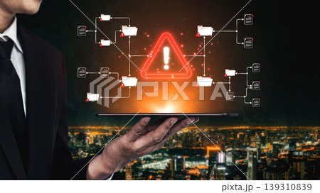 A businessman presents a tablet displaying a warning symbol amidst digital data flow, emphasizing technology, security, and risk management themes in a modern urban environment. Sigmoid A businessman presents a tablet displaying a warning symbol amidst digital data flow, emphasizing technology, security, and risk management themes in a modern urban environment. Sigmoid 139310839
