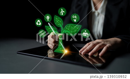 Digital Innovation in Sustainable Development with Green Technology Symbols and Hands Engaging on a Tablet Device for Eco-Friendly Solutions Quark 139310932