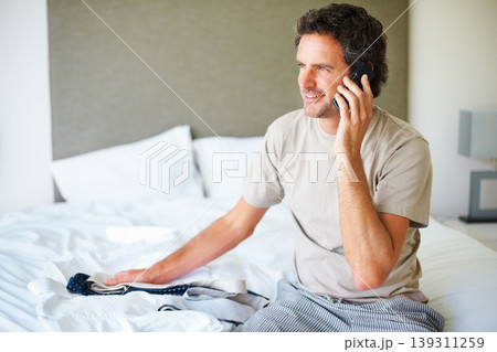 Phone call, home and business man with clothes in bedroom getting ready for work, job and career. Technology, communication and happy person with tie on cellphone for conversation, chat and contact Phone call, home and business man with clothes in bedroom getting ready for work, job and career. Technology, communication and happy person with tie on cellphone for conversation, chat and contact 139311259