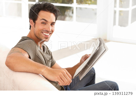 man, portrait and happy with newspaper on sofa for relax, morning break and information in living room. Person, face and smile for article, story and news on couch of apartment for reading or peace man, portrait and happy with newspaper on sofa for relax, morning break and information in living room. Person, face and smile for article, story and news on couch of apartment for reading or peace 139311279