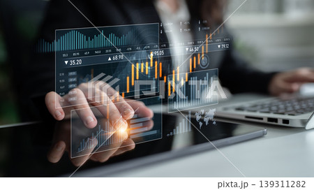 Business Professional Analyzing Financial Data with Digital Graphs on Tablet in Modern Office Setting Scalp Business Professional Analyzing Financial Data with Digital Graphs on Tablet in Modern Office Setting Scalp 139311282