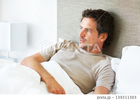 Thinking, depression and man in bed with mental health crisis, disaster or broken heart in his home. Overthinking, face and person in a bedroom with anxiety, stress or frustrated by insomnia fatigue Thinking, depression and man in bed with mental health crisis, disaster or broken heart in his home. Overthinking, face and person in a bedroom with anxiety, stress or frustrated by insomnia fatigue 139311303