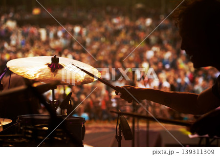 Drummer, music and crowd at stage, concert or musician in performance at festival or event with fans. Playing, rock or man on drums in a metal band with audience listening to beat, sound or show Drummer, music and crowd at stage, concert or musician in performance at festival or event with fans. Playing, rock or man on drums in a metal band with audience listening to beat, sound or show 139311309