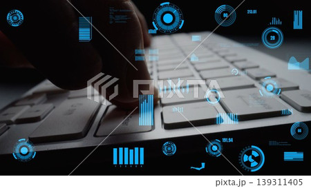 Close-Up of Hand Pressing Key on Modern Keyboard with Futuristic Data Visualization and Graphical Overlays in Dark Environment xenic 139311405