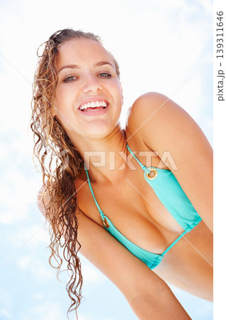 Summer, smile and bikini with portrait of woman on blue sky for swimming, relax and travel vacation. Tropical, happy and holiday with face of person and low angle for outdoor peace and swimwear 139311646