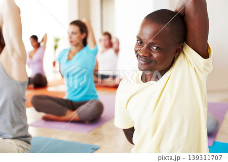 Portrait, stretching and relax, black man in yoga class with smile, commitment and body wellness. Mindfulness, men and women in holistic club together with people, balance and fitness with pilates. 139311707