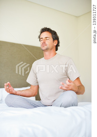 Lotus hands, yoga pose and man on bed with meditation, peace and mental health wellness in his home. Breathing, balance and male person relax in bedroom with spiritual, healing or holistic self care Lotus hands, yoga pose and man on bed with meditation, peace and mental health wellness in his home. Breathing, balance and male person relax in bedroom with spiritual, healing or holistic self care 139311727
