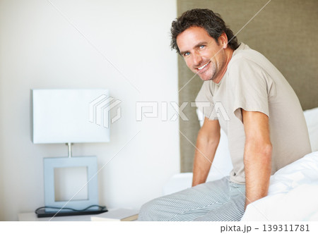 Portrait, smile and man on bed in the morning after nap, break and awake from comfortable sleep at home. Happy mature guy wake up, relax in bedroom and apartment for healthy rest, routine or cosy day Portrait, smile and man on bed in the morning after nap, break and awake from comfortable sleep at home. Happy mature guy wake up, relax in bedroom and apartment for healthy rest, routine or cosy day 139311781