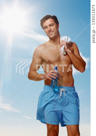 Portrait, towel and man with water for fitness, sport workout or wellness exercise outdoor in summer on blue sky. Smile, drink bottle and hydration of shirtless person, healthy body muscle and abs Portrait, towel and man with water for fitness, sport workout or wellness exercise outdoor in summer on blue sky. Smile, drink bottle and hydration of shirtless person, healthy body muscle and abs 139311873
