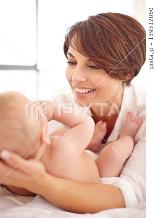Mother, baby and happiness or love, play and relaxing on bed, bonding and joy in parenthood. Mom, newborn and peace or calm at home, positive and happy for child development, smile and fun together Mother, baby and happiness or love, play and relaxing on bed, bonding and joy in parenthood. Mom, newborn and peace or calm at home, positive and happy for child development, smile and fun together 139312060