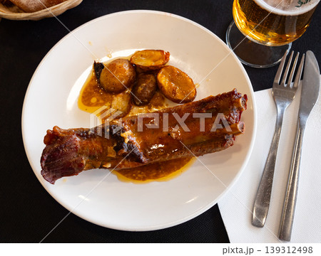 Fried pork ribs served with potatoes on plate Fried pork ribs served with potatoes on plate 139312498