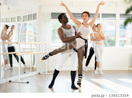 Ballet partners performing elegant dance sequence in studio Ballet partners performing elegant dance sequence in studio 139313354