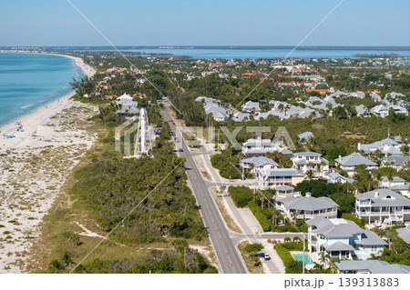 Expensive waterfront houses between green palm trees in Boca Grande, small town on Gasparilla Island in southwest Florida. Premium housing development in the USA Expensive waterfront houses between green palm trees in Boca Grande, small town on Gasparilla Island in southwest Florida. Premium housing development in the USA 139313883