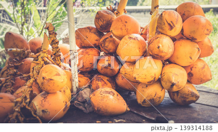 King coconut bunch on a table with a knife King coconut bunch on a table with a knife 139314188