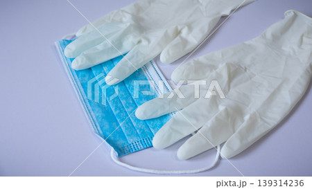 Medical face mask and pair of latex medical gloves Medical face mask and pair of latex medical gloves 139314236