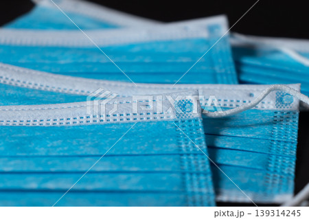 Surgical masks close up dark background Surgical masks close up dark background 139314245