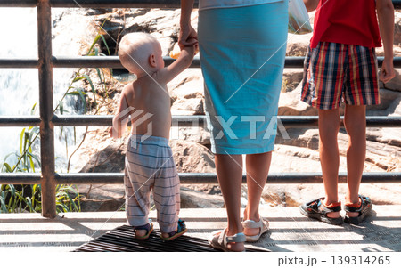 Small child Hand held by caring mother from behind photograph 139314265
