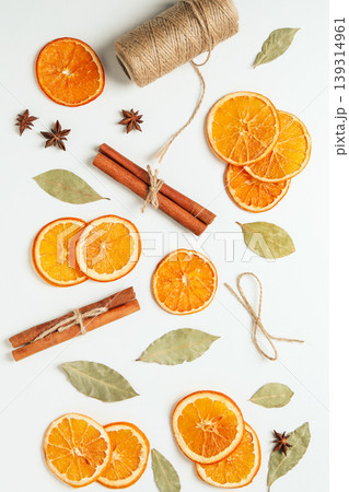 Dried oranges and cinnamon on a white background Dried oranges and cinnamon on a white background 139314961