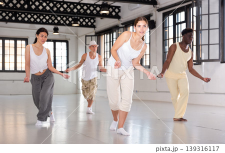 Four dancers exercising swing movements 139316117