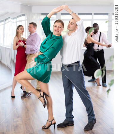 Man and woman dancing waltz in couple during lesson at studio Man and woman dancing waltz in couple during lesson at studio 139316201